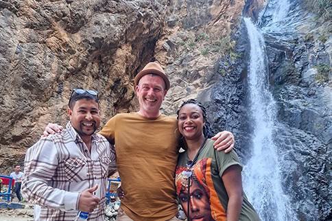 Happy guests at a waterfall